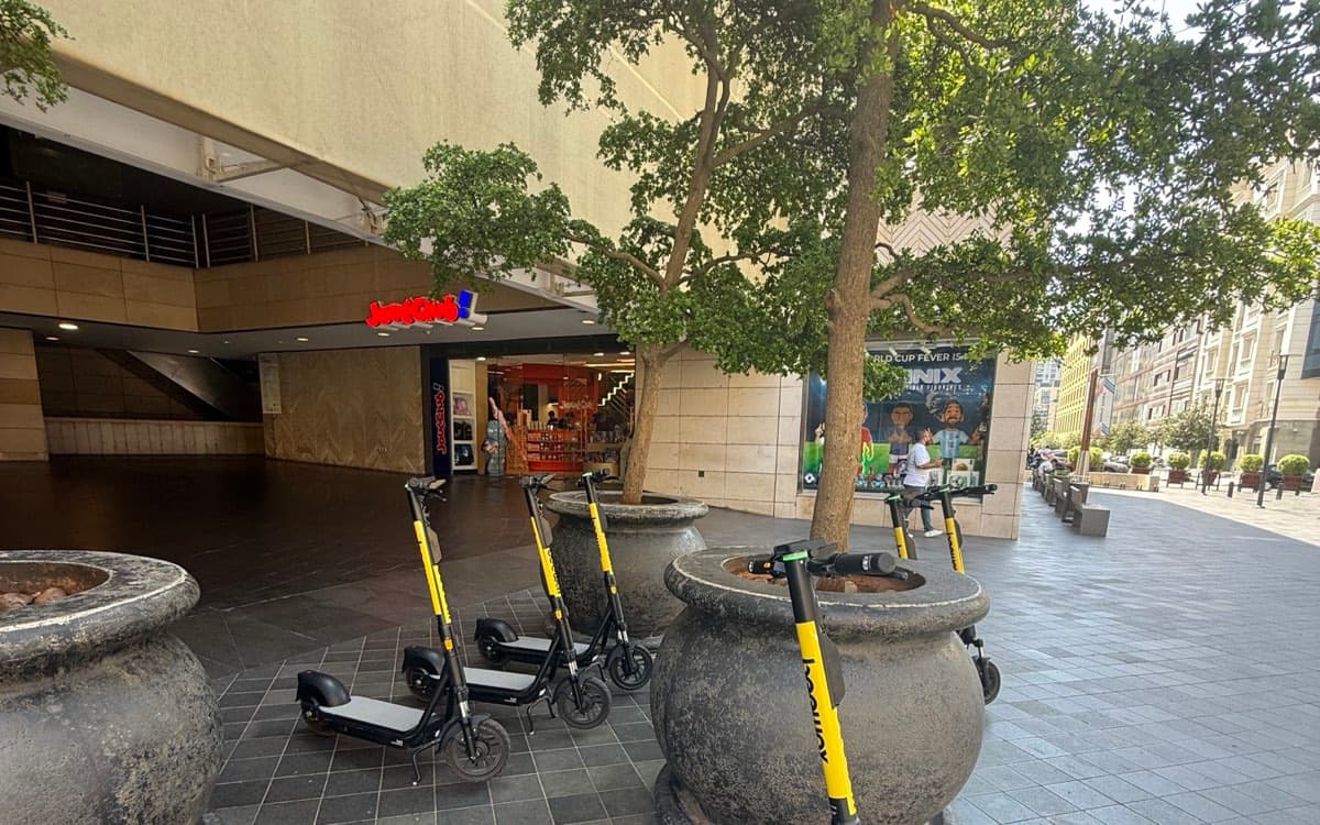 BeeWay scooters parked under the trees outside JouéClub in Beirut Souks